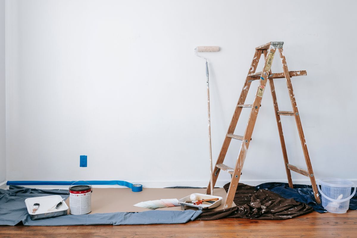Room after renovation with ladder and painting supplies